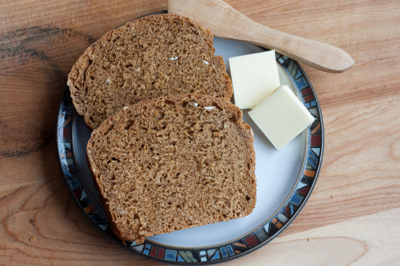 two slices of bread on plate with butter