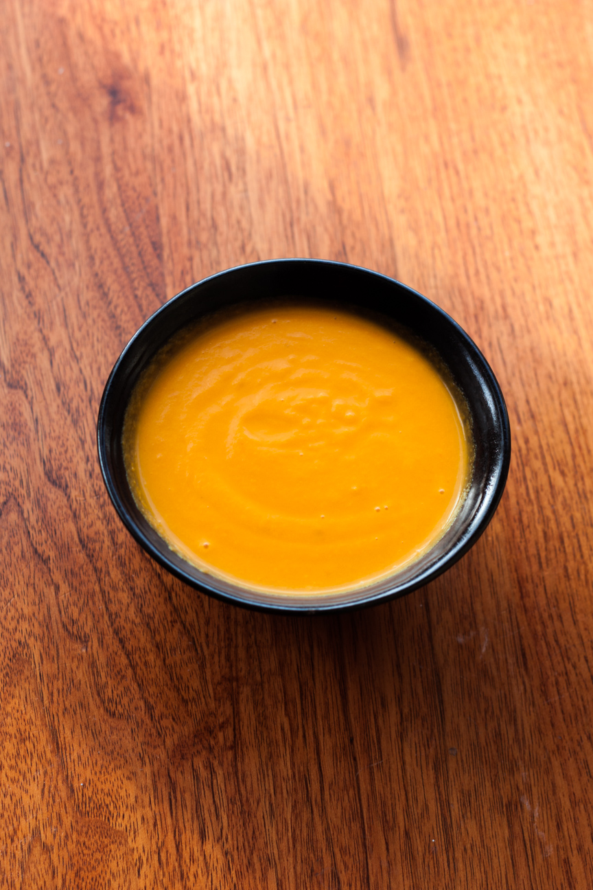 carrot lemon soup in bowl on table