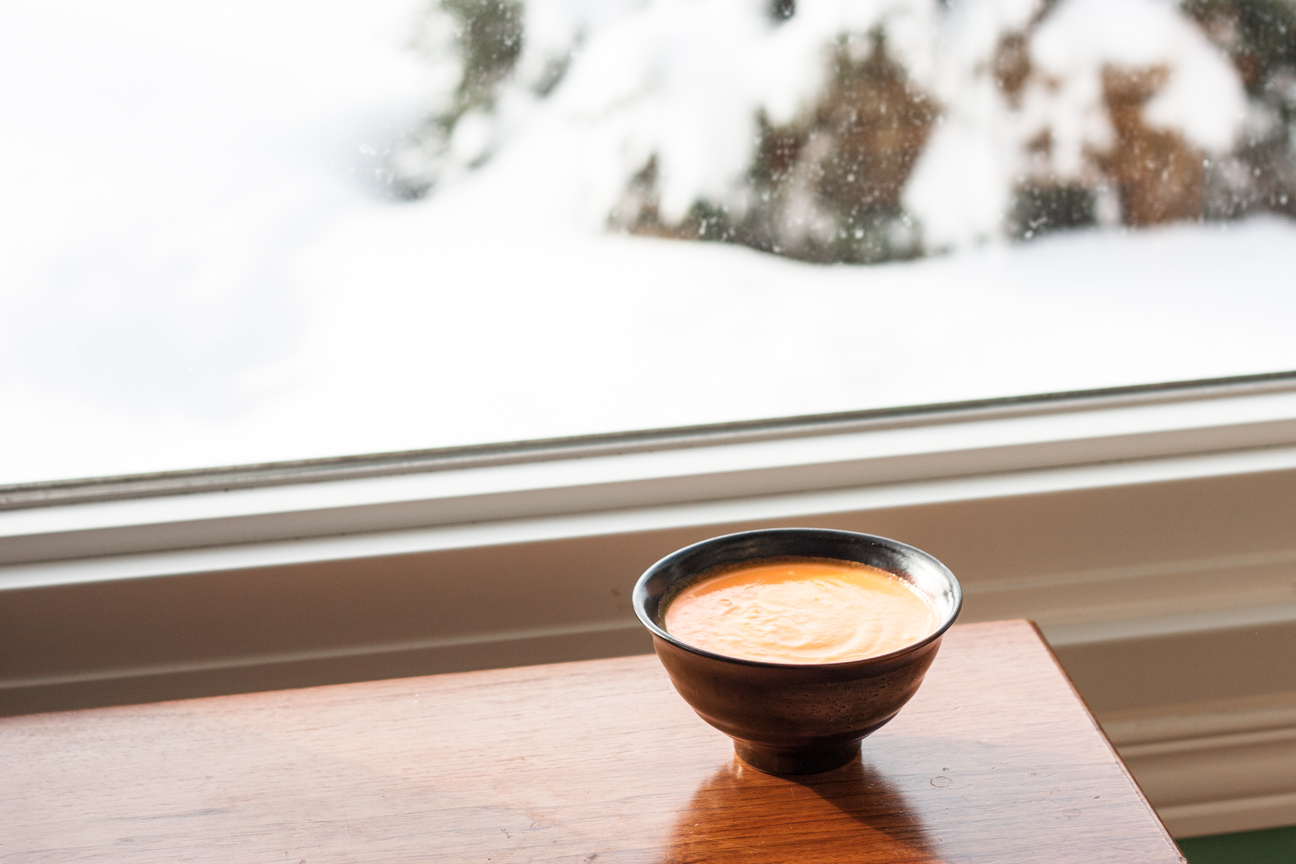 carrot lemon soup in bowl near window