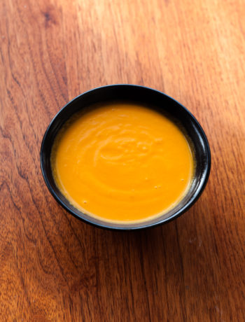 carrot lemon soup in bowl on table