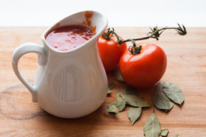 pitcher of tomato sauce with tomatoes