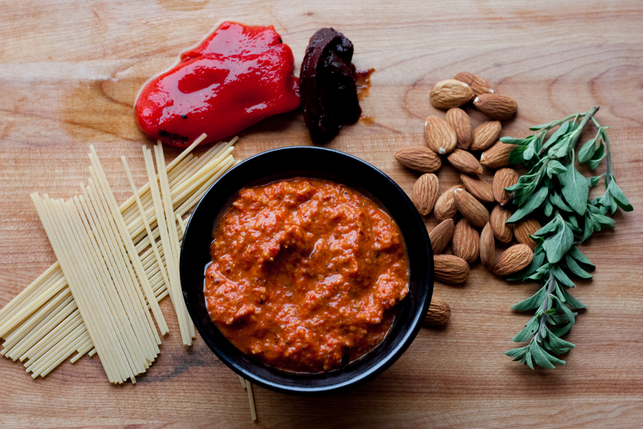 roasted red pepper pesto with ingredients on a cutting board