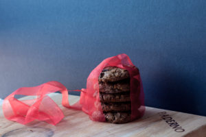 stack of mocha chocolate chip oat cookies with red ribbon