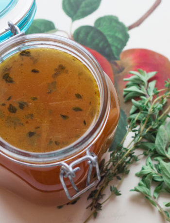 vegetable stock in a jar with fresh herbs