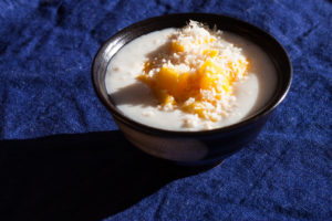 bowl of porridge with mango and coconut