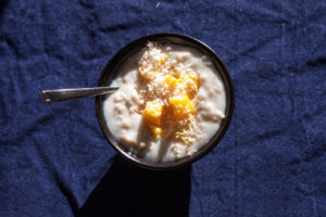 bowl of porridge with mango and coconut