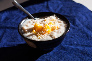 bowl of porridge with coconut and mango