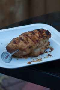 grilled chicken breast on plate with meat thermometer
