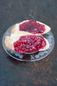 red gooseberry elderflower jam on baguette