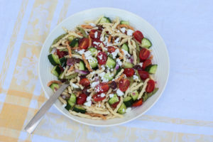 greek horiatiki pasta salad in a bowl