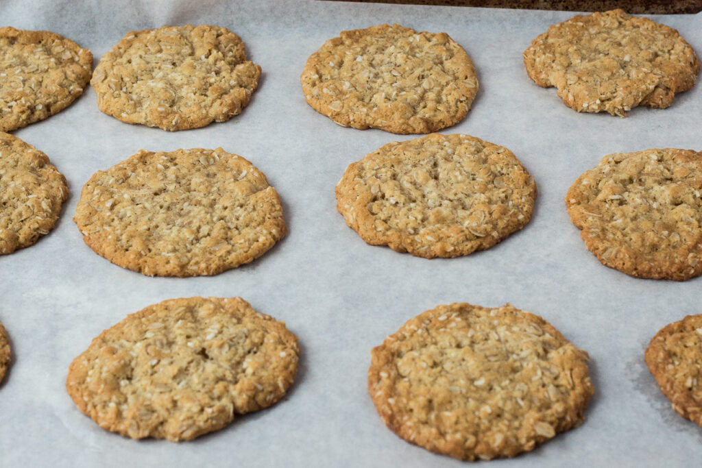 orange maple anzac cookies on baking tray