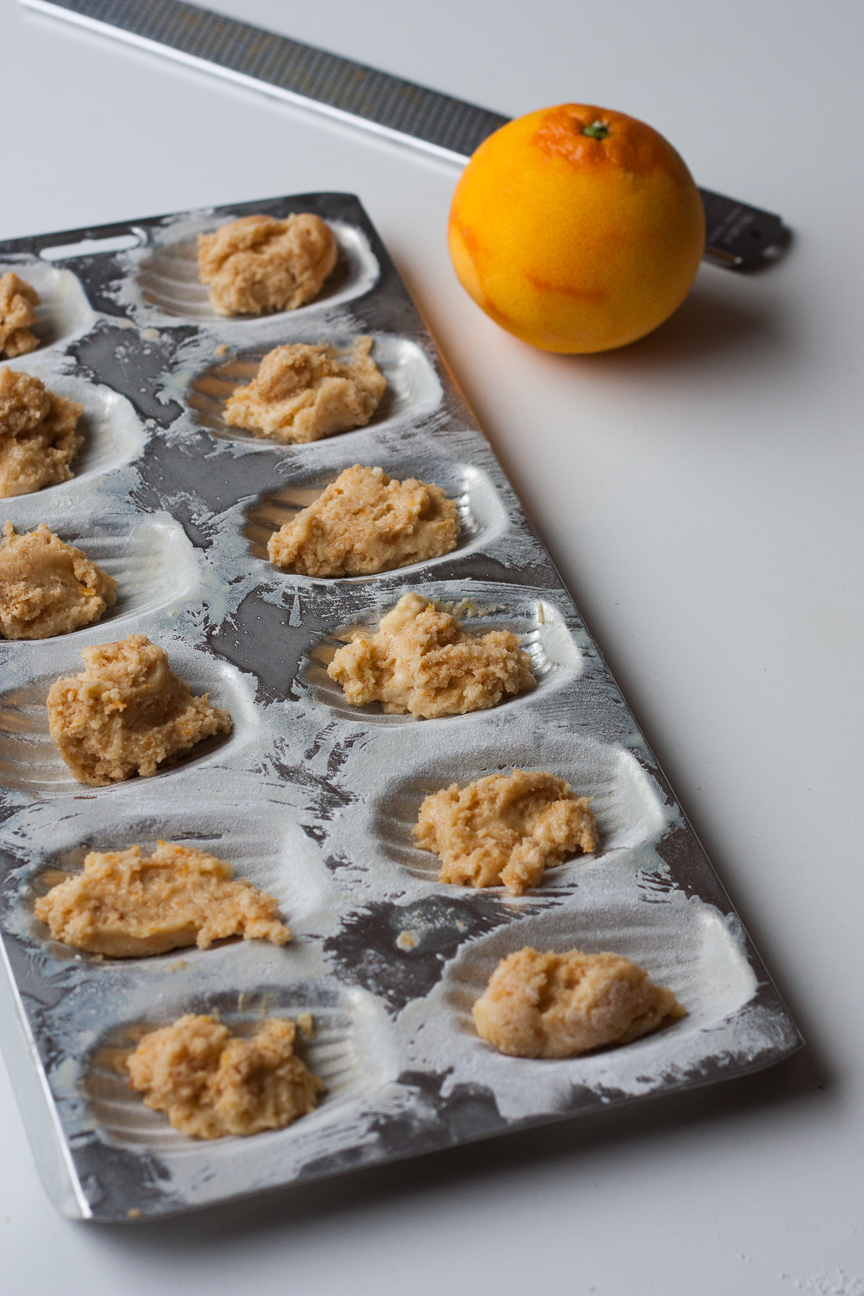 raw dough of brown butter orange hazelnut madeleine in the madeleine tray