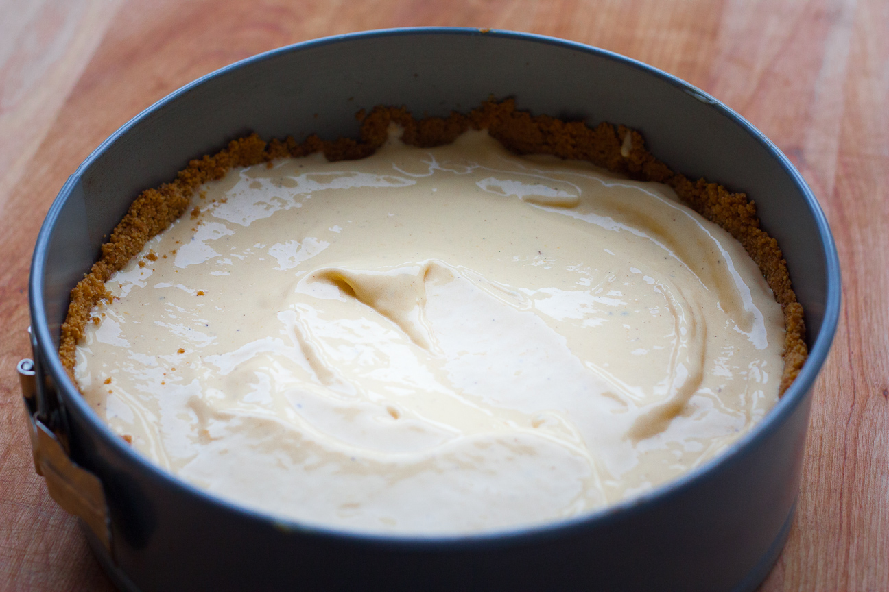 mango ice cream inside graham cracker crust as the bottom layer of a cake