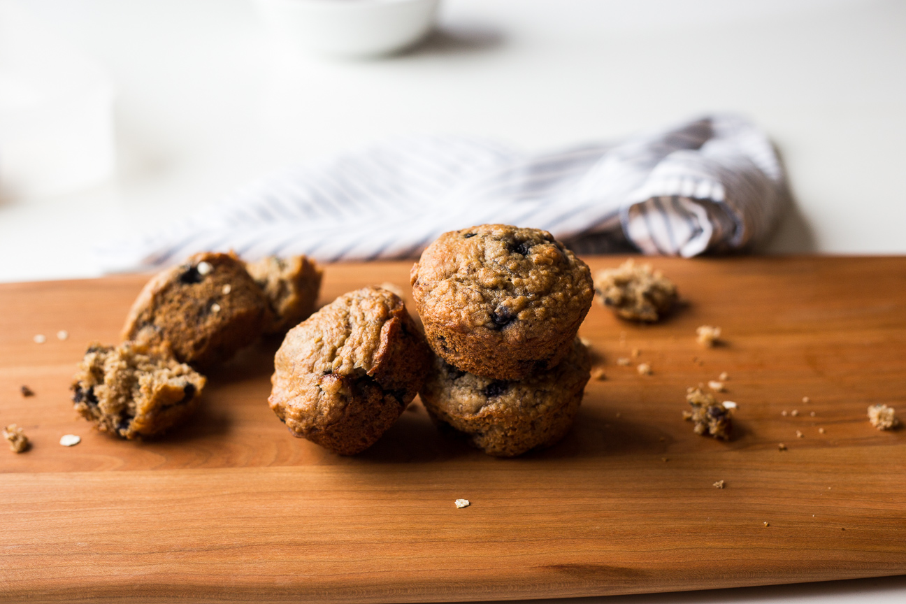 blueberry banana muffins stacked on cutting board