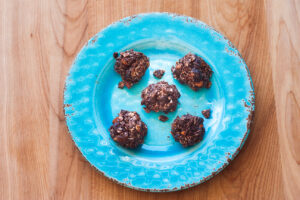 chocolate peanut butter energy balls on a blue plate
