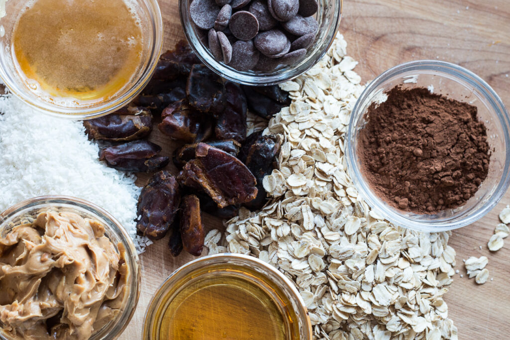 separate piles of ingredients for chocolate peanut butter energy balls