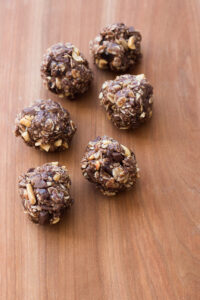 chocolate peanut butter energy balls on a wooden board