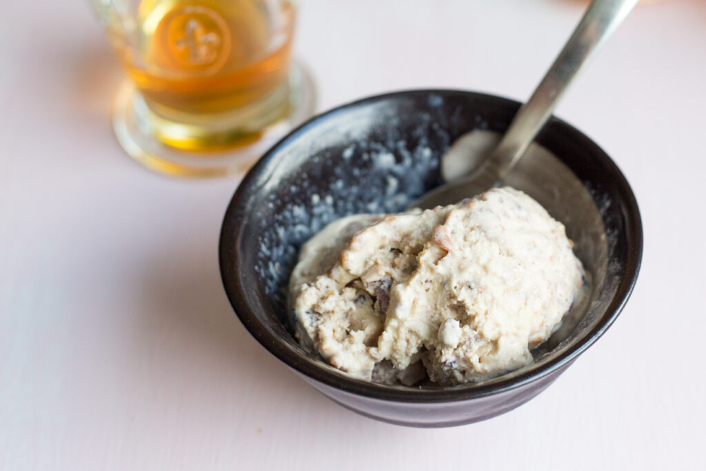 a bowl of ice cream with a glass of liqueur