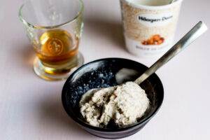 a bowl of ice cream with a glass of liqueur