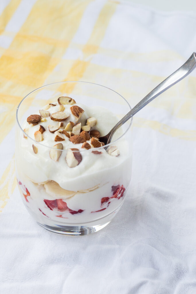 ashta and fruit and nuts in a parfait glass