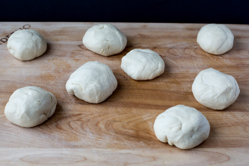 8 balls of dough on a cutting board