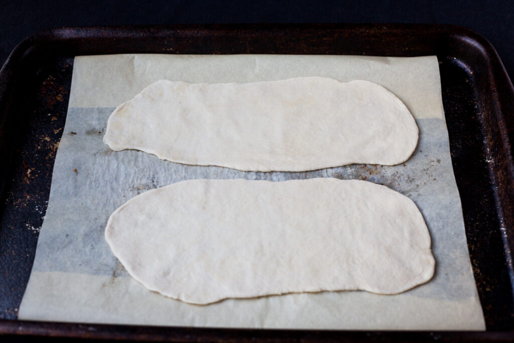 dough rolled out on a cookie tray